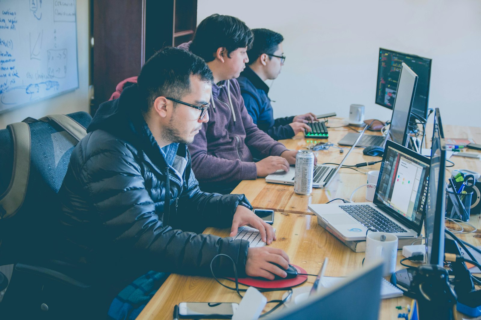 Engineers working together at computer monitors