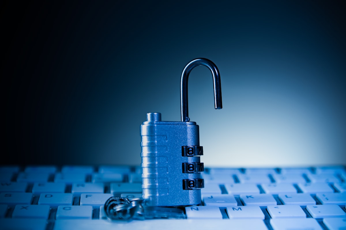 An unlocked padlock resting on a computer keyboard, symbolizing the exposed security gap that unmonitored browser extensions create