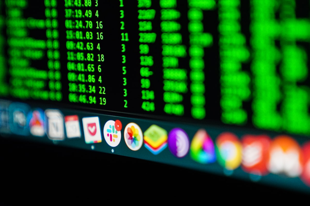 A monitor displaying code and security data, illustrating the technical permissions AI browser extensions can access