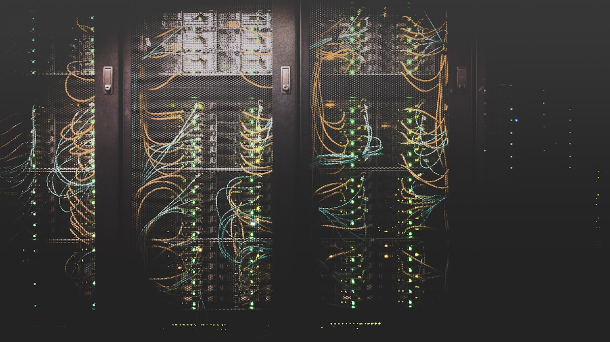 Dense rows of servers in a modern data center with blue LED lighting, representing the infrastructure complexity that comes with unmanaged technology sprawl