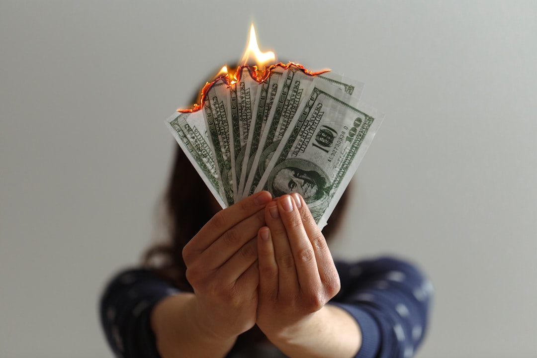 Burning US dollar banknotes, illustrating the scale of wasted cloud infrastructure spending