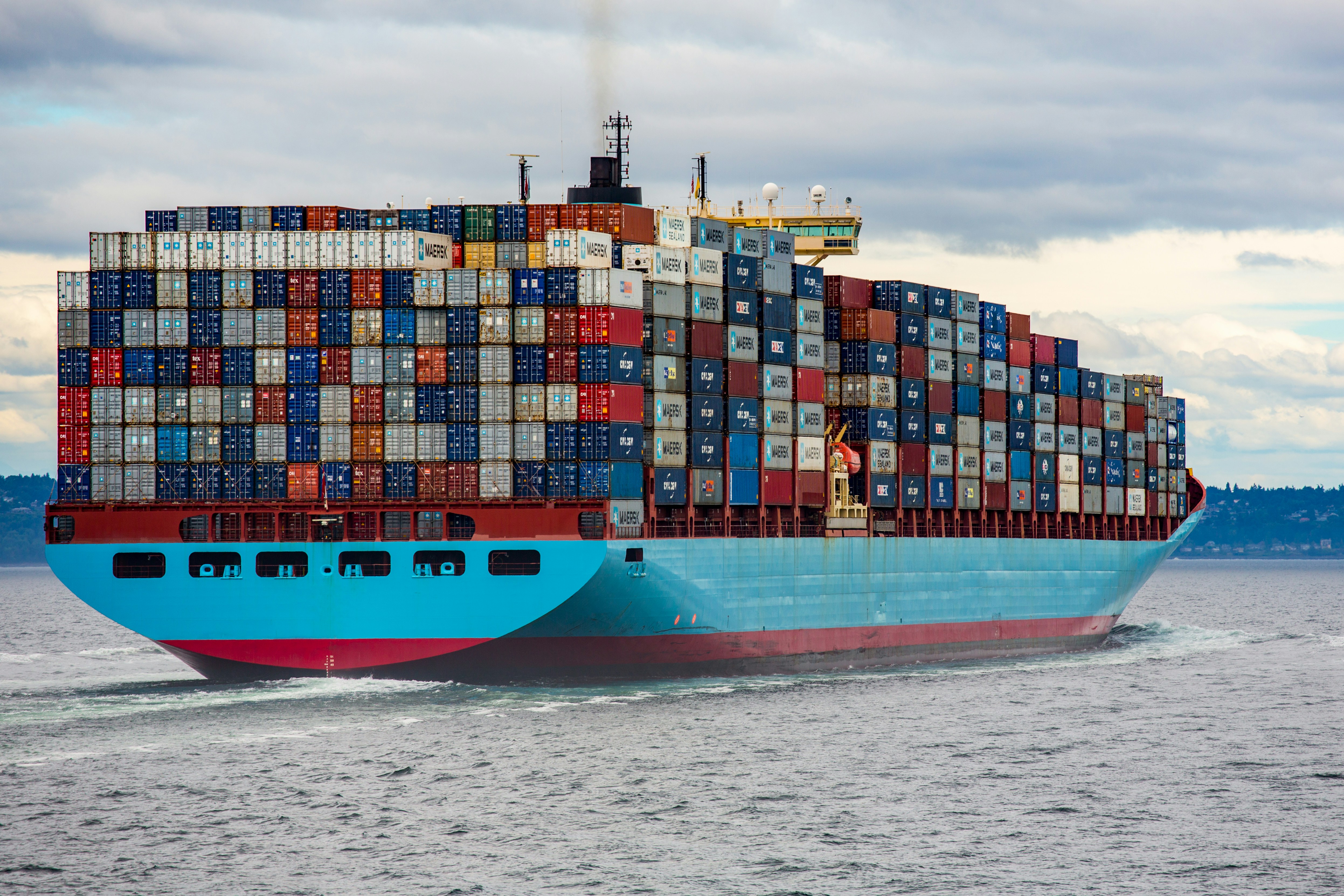 Colorful shipping containers stacked at a port, representing the containerization and portability of modern cloud workloads