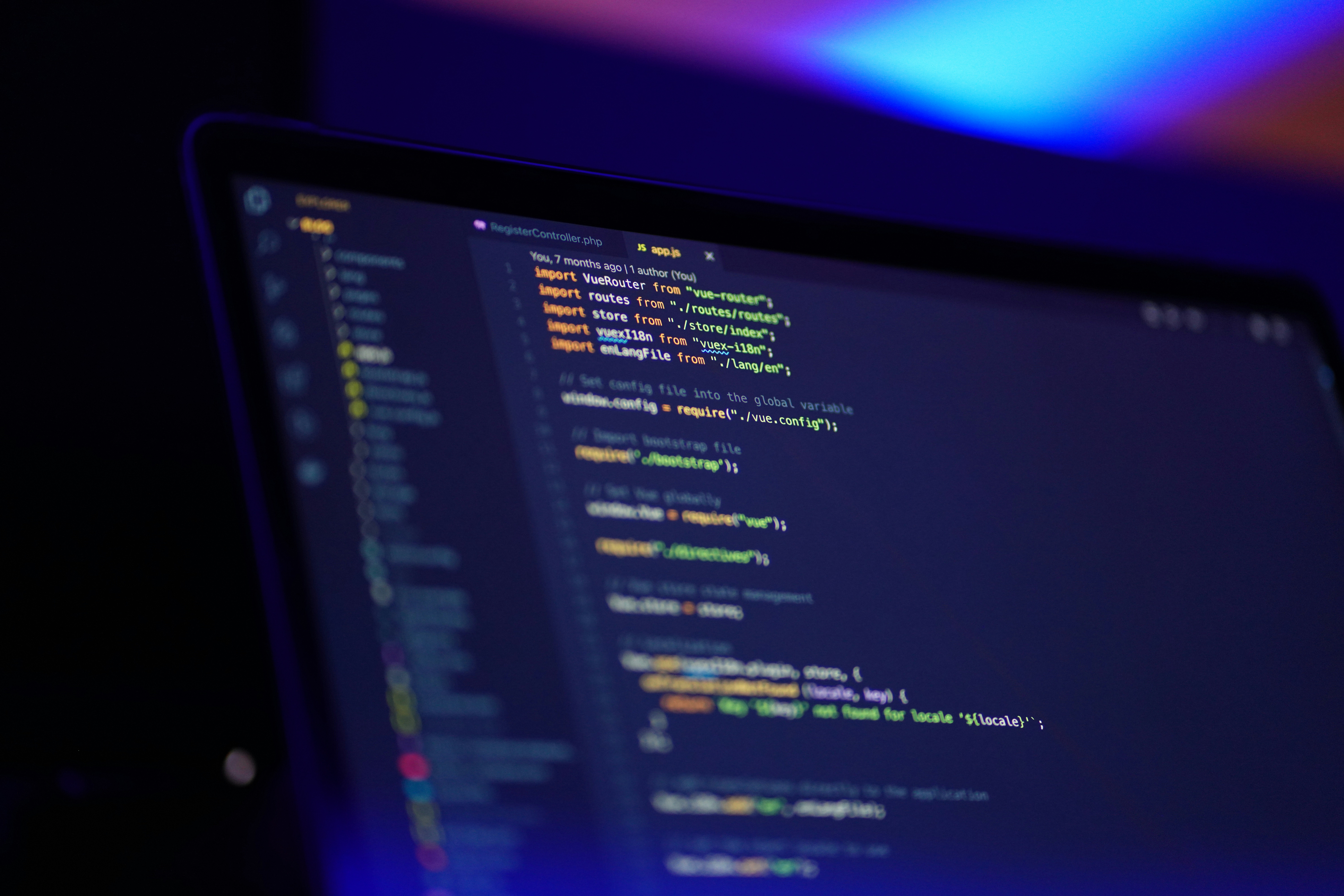 Lines of code displayed on a developer's monitor in a dark workspace