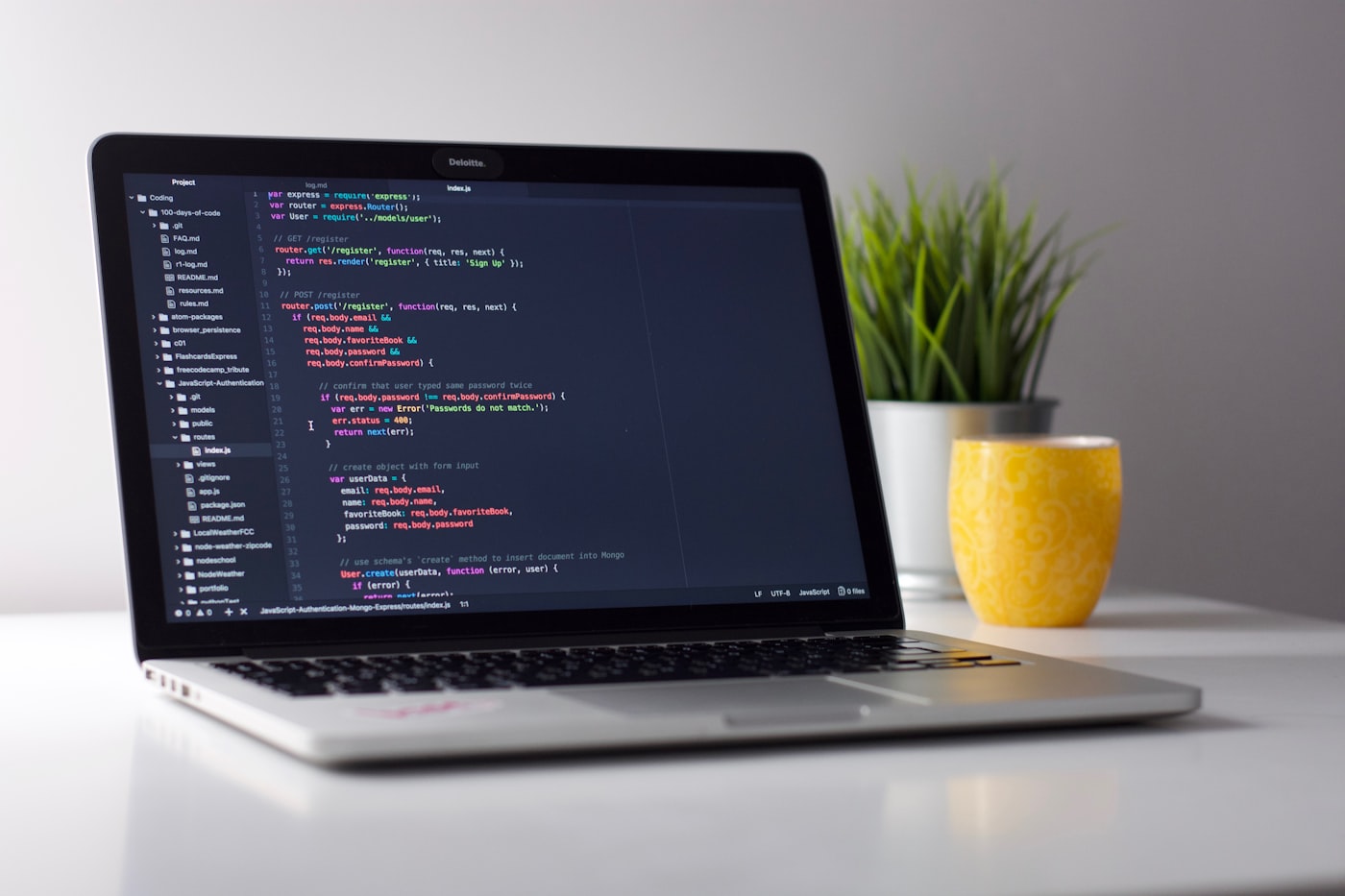 Laptop with code on screen, representing the open-source contribution of Metric Views to Apache Spark